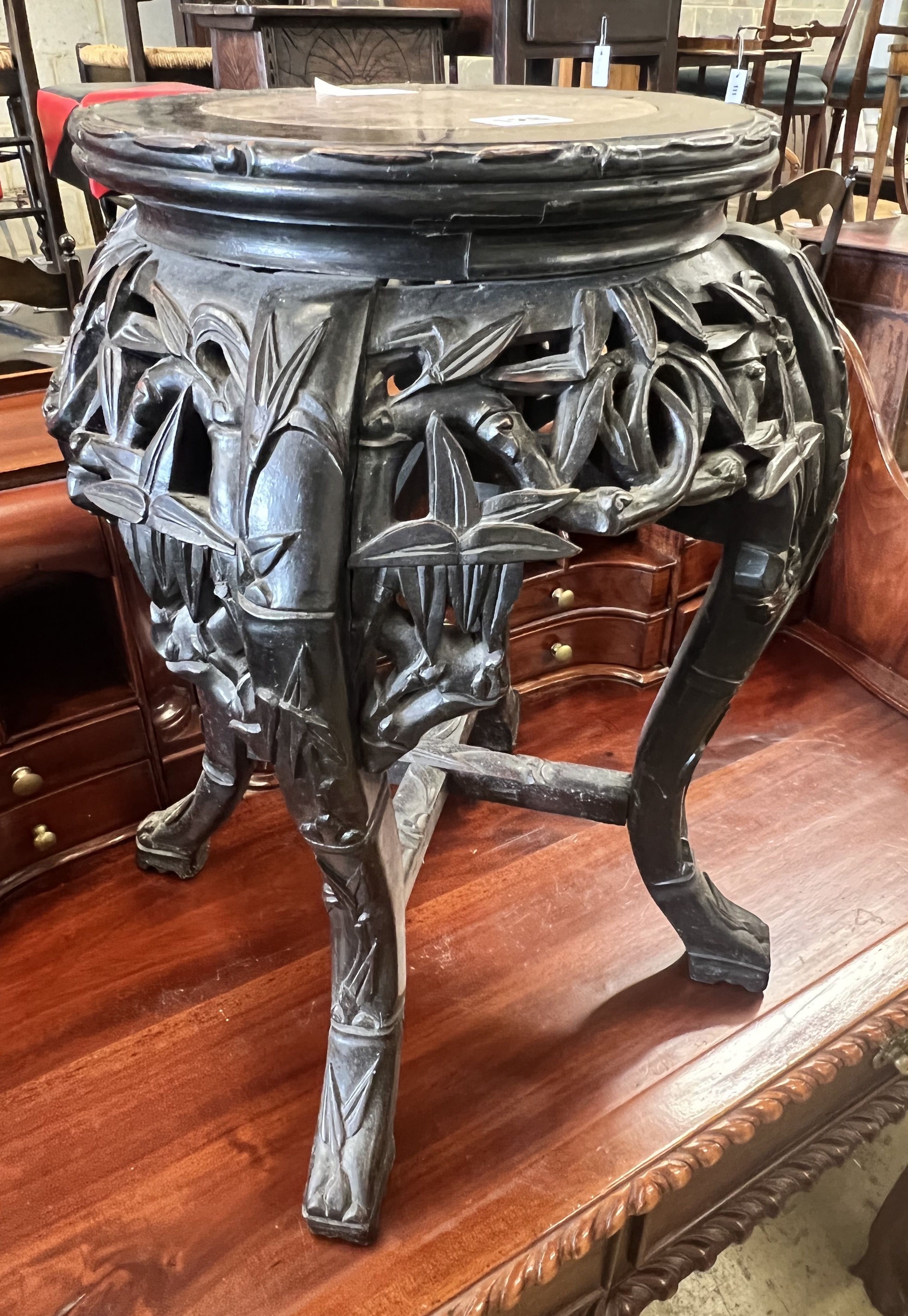 A Chinese carved hardwood circular marble topped vase stand, width 32cm height 47cm